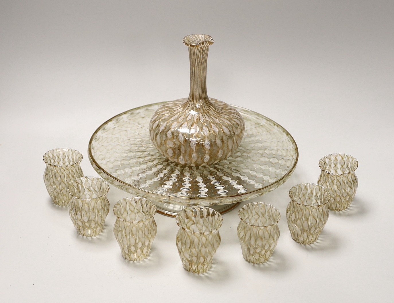 An Italian Salviati latticino and aventurine glass apperitif set, pedestal tray, seven glasses and a carafe